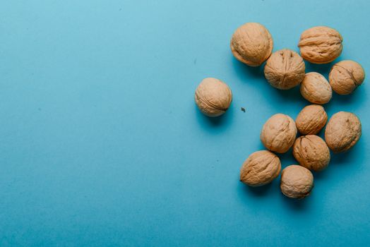 Walnuts, walnuts close-up, walnuts on a blue background