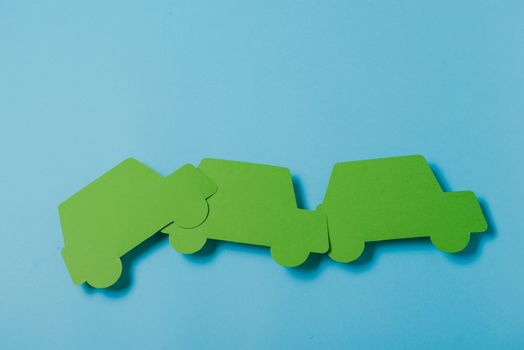 paper green cars figure. top view on blue background