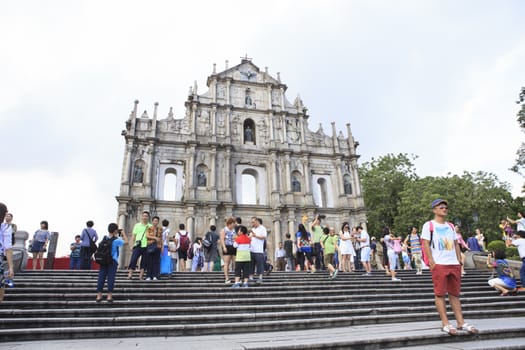 MACAU CHINA-AUGUST 22 : tourist standing and take a photo in front of Ruins Saint Paul's Cathedral important landmark of tourist destination in Macau visiting on august 22,2014 in Macau China 