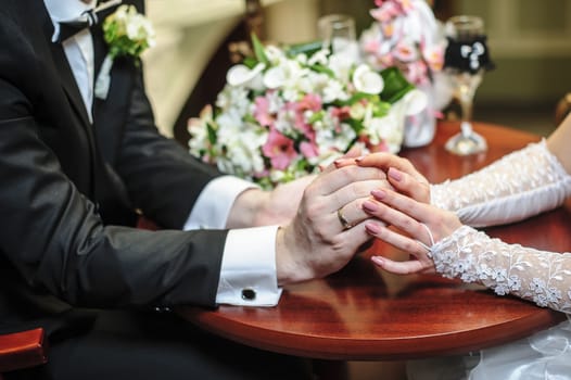 Hands of bride and groom with rings