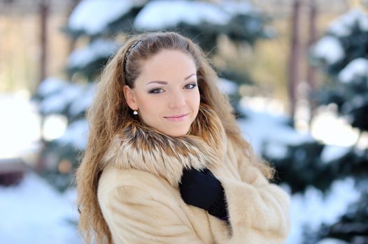 Attractive young woman in wintertime outdoor 