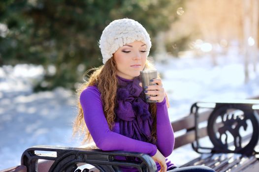 Woman holding hot coffee on winter day 