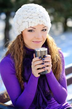 Beautiful Happy Smiling Winter Woman with Mug Outdoor. Laughing Girl Outdoors with Hot Drink 