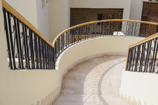 curved stairway in luxury shopping mall 