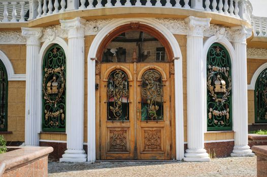 wooden door with forged metal grate 