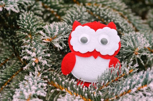 Christmas owl on a snowy tree in winter