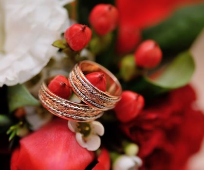 Two wedding rings on bridal bouquet