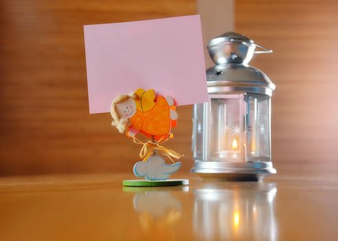 Burning candle in glass decorative candlestick on wooden desk, with place for your text