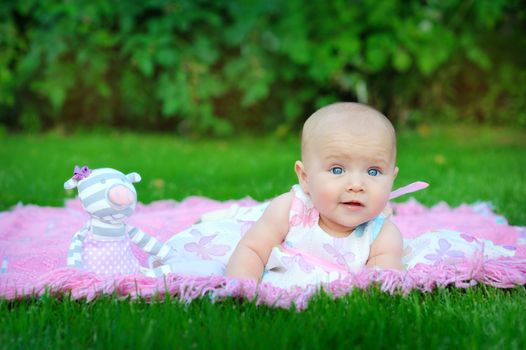 little pretty girl playing on the lawn 