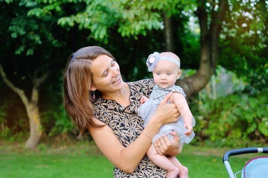 beautiful young mother and her daughter in the park.