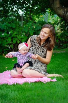 beautiful young mother and her daughter in the park 