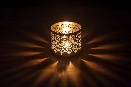lighted candle in a candlestick