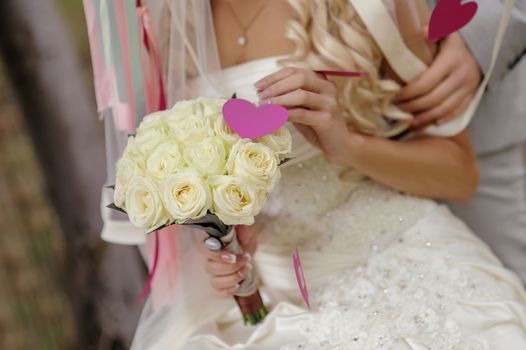 wedding bouquet in hands of the bride of roses