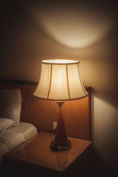 Turned On Old Lamp near the wall 