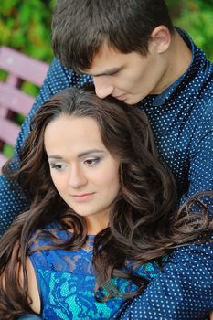 Thoughtful couple hugging and looking up