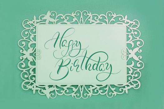 greeting card with text Happy Birthday on green background. Calligraphy lettering.