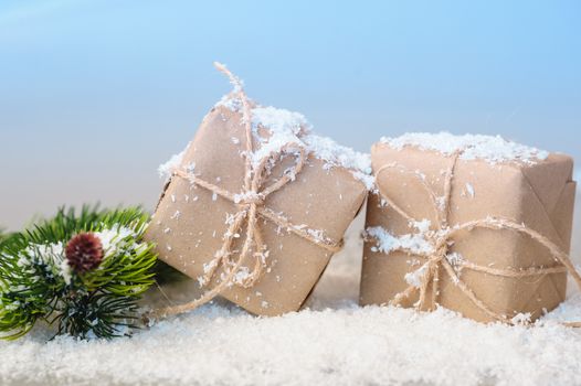 gift boxes of kraft paper with spruce branches on white background.