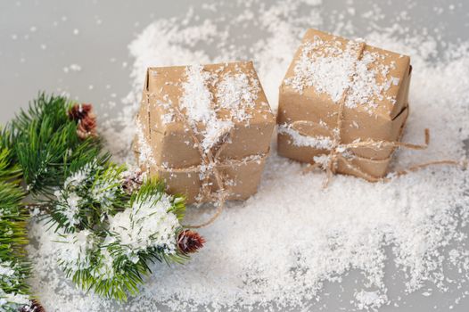 gift boxes of kraft paper with spruce branches on white background.