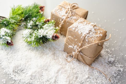 gift boxes of kraft paper with spruce branches on white background.