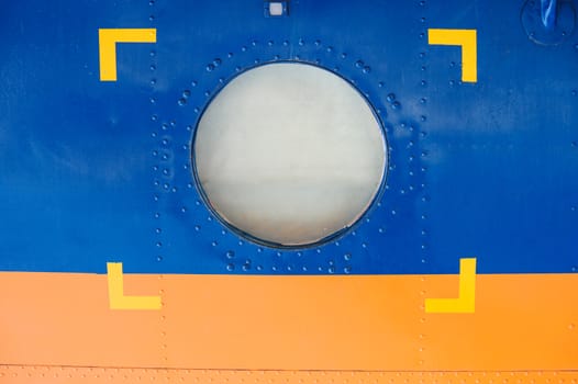 porthole in the plane covered with the metal plate.