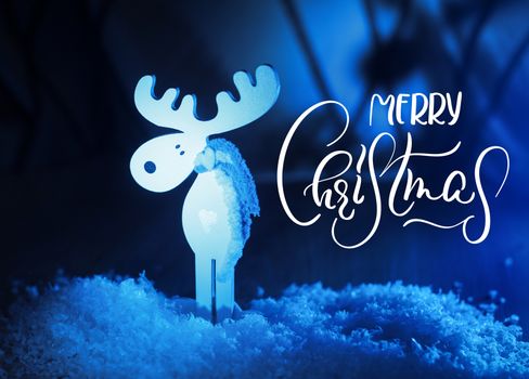 White toy Moose and Merry Christmas text. Calligraphy lettering.