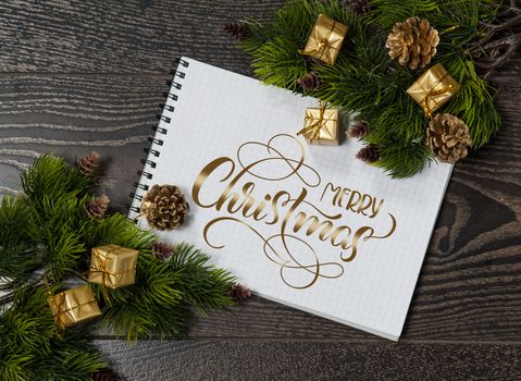 background of tree branches and space for greetings with text Merry Christmas. Calligraphy lettering.