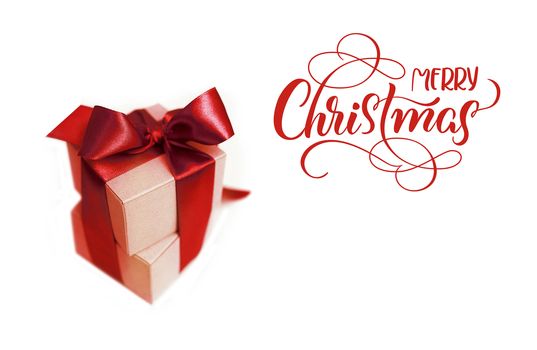 Gift boxes with brown bow on a white background and text Merry Christmas. lettering calligraphy.