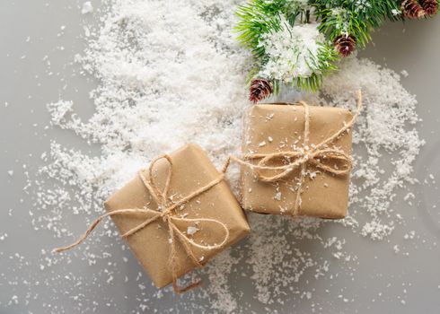 gift boxes of kraft paper with spruce branches on white background