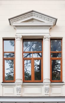 window on the facade of the old architectural building with arch.