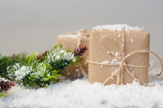 gift boxes of kraft paper with spruce branches on white background