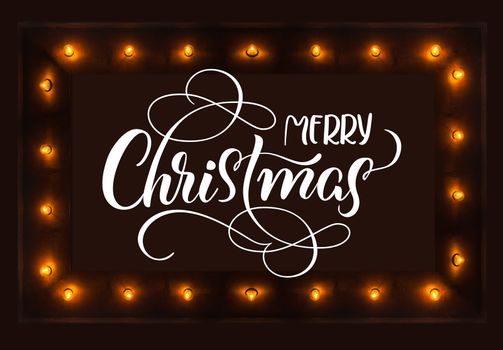 dark background with light bulbs and Merry Christmas text. Calligraphy lettering.
