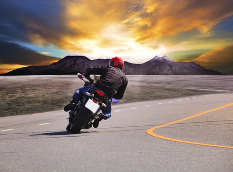rear view of young man riding motorcycle in asphalt road curve with rural and mountain scene  background 