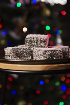 Group of Lamingtons on a metal baking tray.