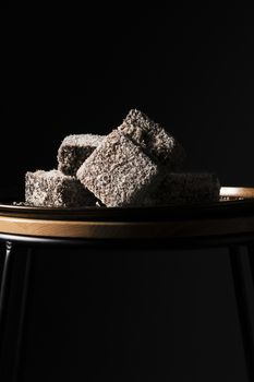 Group of Lamingtons on a metal baking tray.