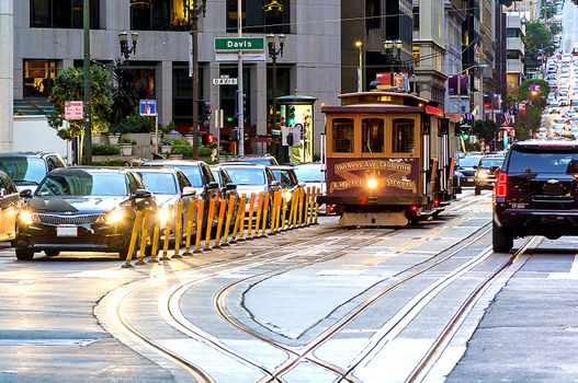 traditional cable car in the traffic of San Francisco