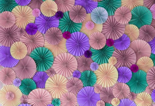 Romantic colorful celebration background wall with multicolored paper circles of pink, lilac, purple, green and beige colors