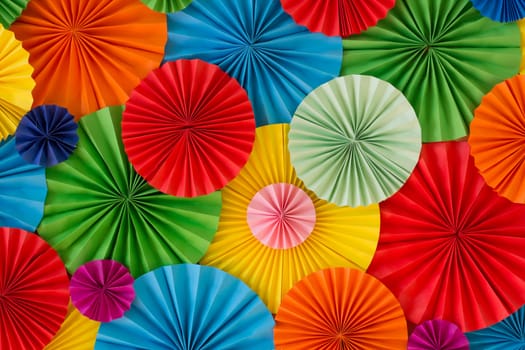 Colorful birthday celebration background wall with multicolored paper circles of red, yellow, blue, orange, green colors