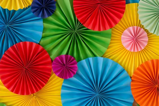 Colorful birthday celebration background wall with multicolored paper circles of red, yellow, blue, orange, green colors