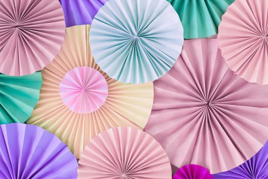 Romantic colorful celebration background wall with multicolored paper circles of pink, lilac, purple, green and beige colors