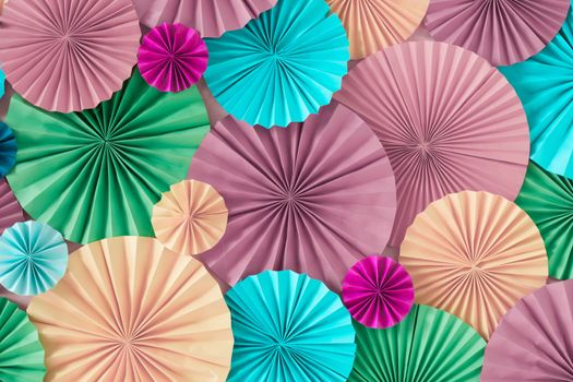 Colorful celebration background wall with multicolored paper circles of pink, beige, yellow, green and blue