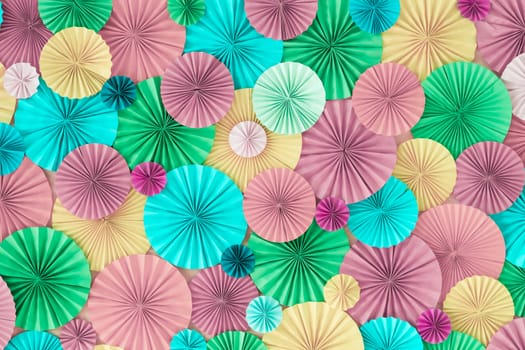 Colorful celebration background wall with multicolored paper circles of pink, lilac, yellow, green and blue colors