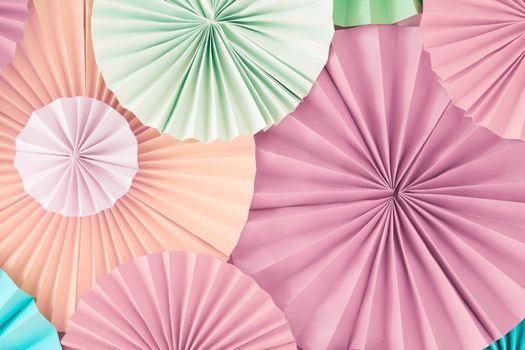 Colorful celebration background wall with multicolored paper circles of pink, beige, yellow
