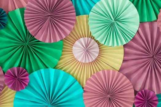 Colorful celebration background wall with multicolored paper circles of pink, lilac, yellow, green and blue colors