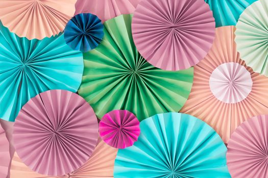 Colorful celebration background wall with multicolored paper circles of pink, beige, yellow, green and blue