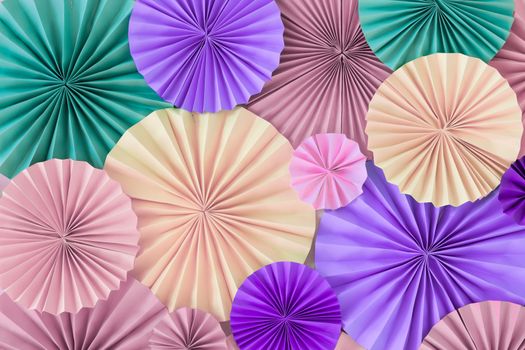 Romantic colorful celebration background wall with multicolored paper circles of pink, lilac, purple, green and beige colors