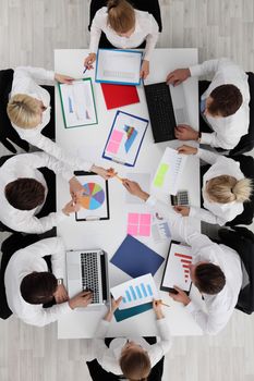 Top view of business people working with financial reports