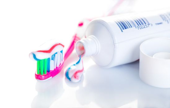 toothbrush with toothpaste close-up on white background