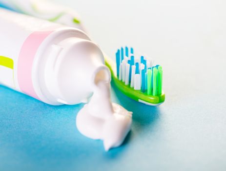 toothbrush with toothpaste close-up on blue background