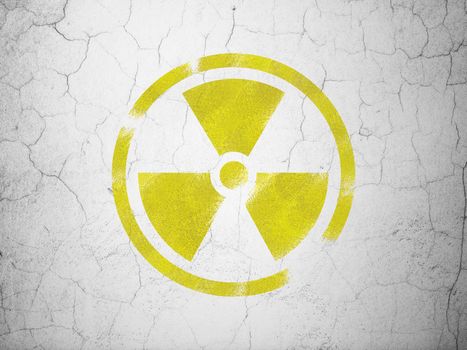 Science concept: Yellow Radiation on textured concrete wall background