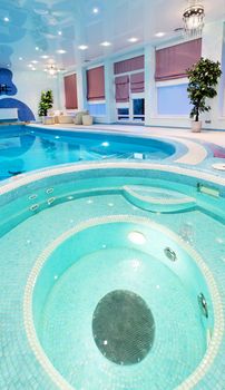 Round swimming pool design with blue mosaic
